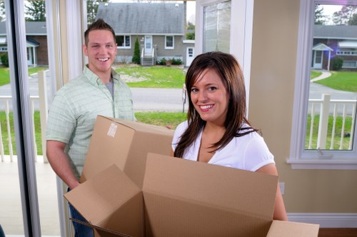 Professional movers loading packed boxes into a removal van in Hampstead